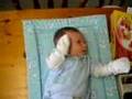 suepj -.Cute baby in mittens shadow boxing on the table in 2007